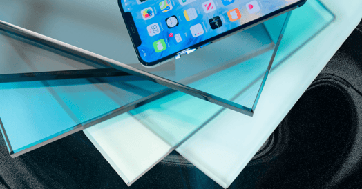 A stack of blue glass with an iPhone on top.