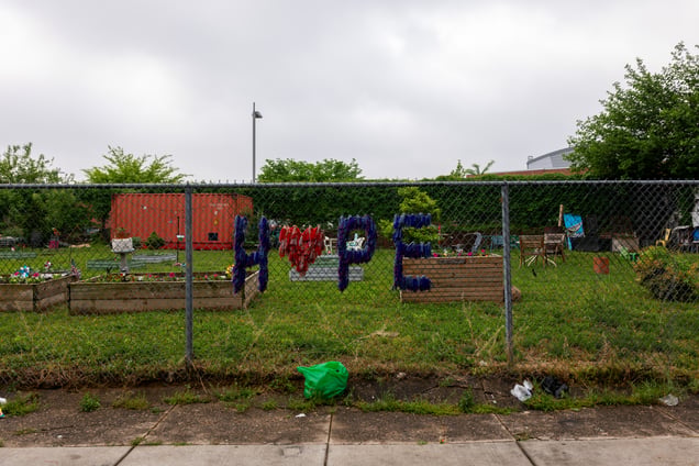 A community garden in Kensington with the word "HOPE" spelled out in colorful letters among raised beds.