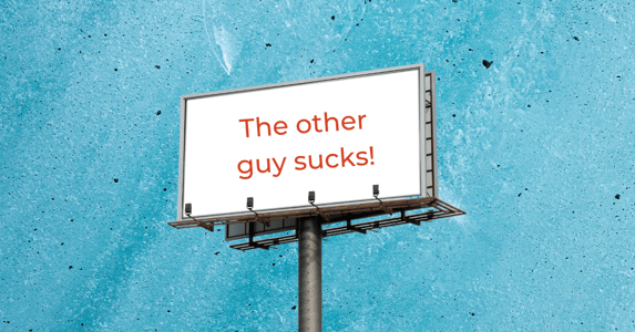 A billboard reads, “The other guy sucks!”