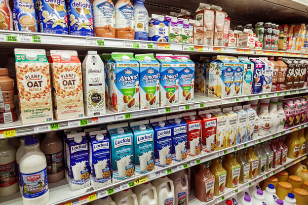 milk and milk products on shelves in a grocery store
