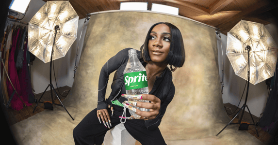 Sha’Carri Richardson holding a bottle of Sprite.