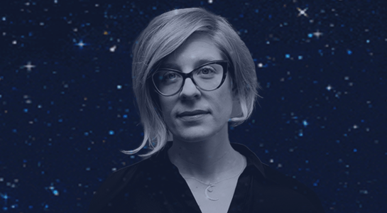 A portrait of Kathryn Nicolai, a woman with short blonde hair and cat-eye glasses, set against a dark, starry background.