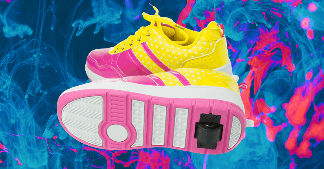 A pair of yellow and pink Heelys. 