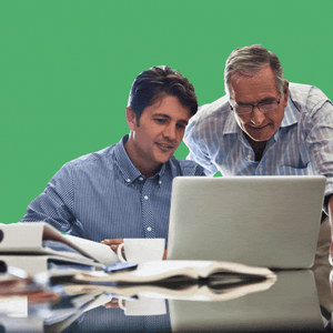 Father and son looking at a computer with a helicopter landing on dad
