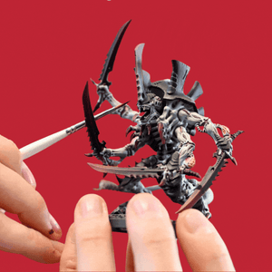 A close-up of someone painting a Warhammer miniature figure. 