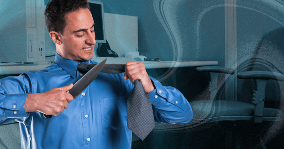 A white man in a blue dress shirt holding up his necktie, about to cut it with a large silver knife.