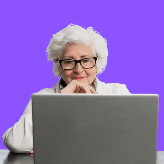 A woman with white hair at a laptop 