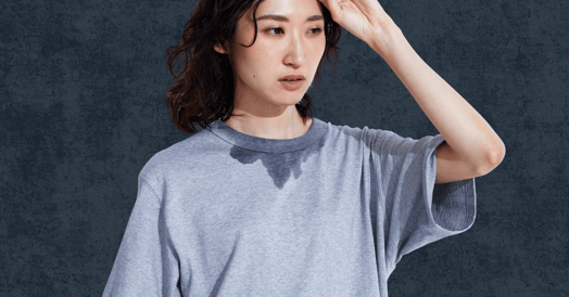 A woman in a sweat-stained T shirt 