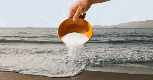 Bowl of salt in front of the ocean