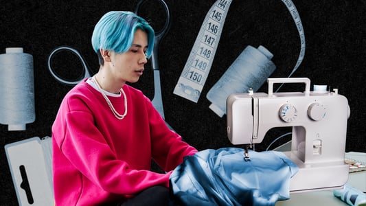 A young man sews a garment on a sewing machine.