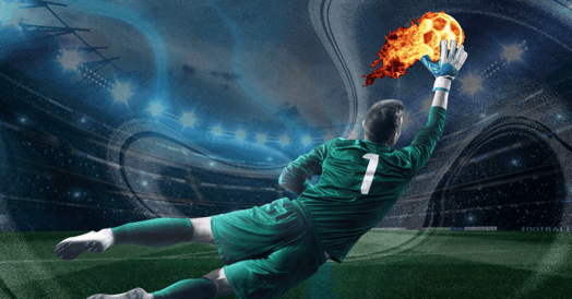A soccer player in a green uniform intercepts a flaming soccer ball.
