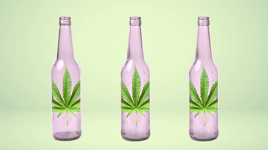 Three glasses bottles, each with a cannabis leaf on it.