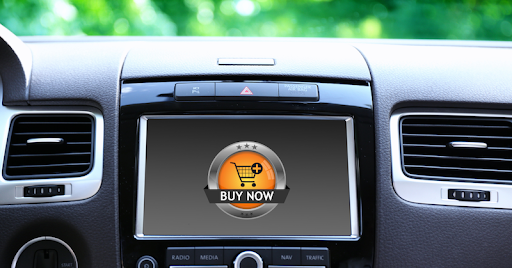 A car’s dashboard with a ‘buy now’ pop-up ad on the display.