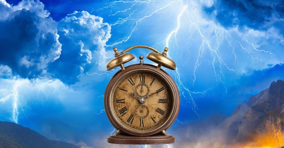 An alarm clock in front of lightning. 