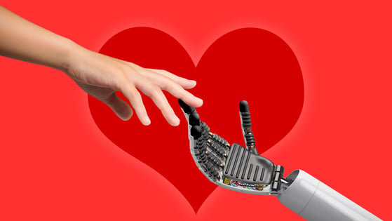 A human hand reaching for a robot's hand in front of a red heart.
