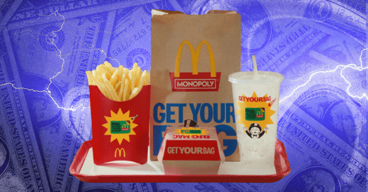 A red tray containing a McDonald's bag promoting its upcoming Monopoly game, a small box containing a hamburger, a paper cup and straw, and a paper container full of fries.