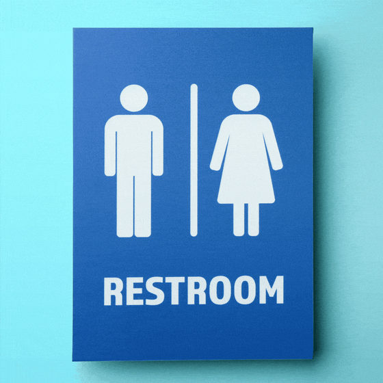 A restroom sign with the female symbol filled with flashing ads.
