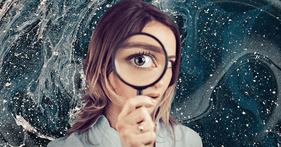 A blonde woman peers into a magnifying glass suspiciously.