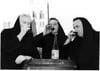 Three monks take a sip of tonic wine