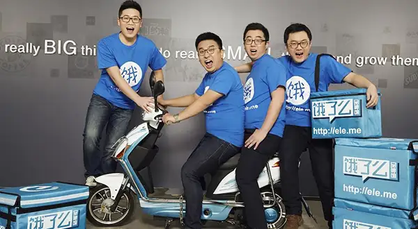 Ele.me team members with a delivery scooter