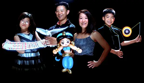 Chan’s son (far right) and daughter (far left) are magicians-in-training, and his wife is a balloon artist